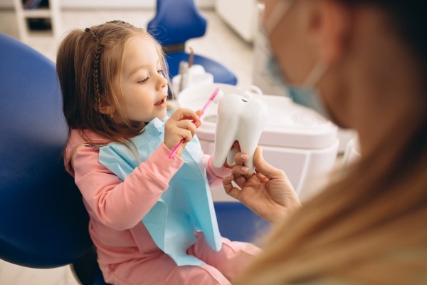 How Does A Pediatric Dentist Recommend Getting A Child To Floss Regularly?